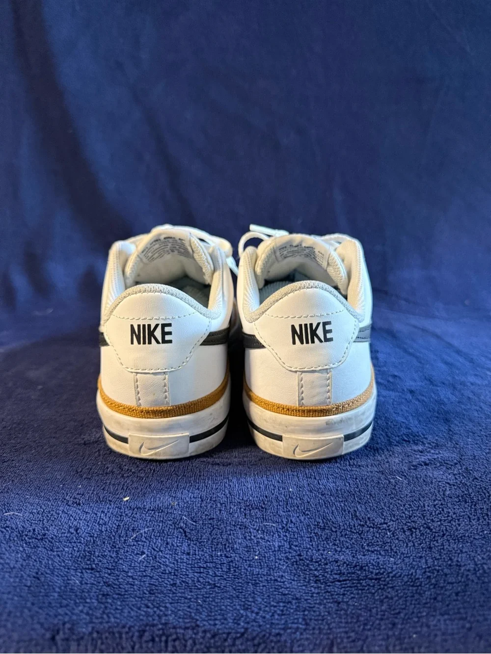 Nike Men’s White Low-Top Sneakers with Black Swoosh and Gold Trim